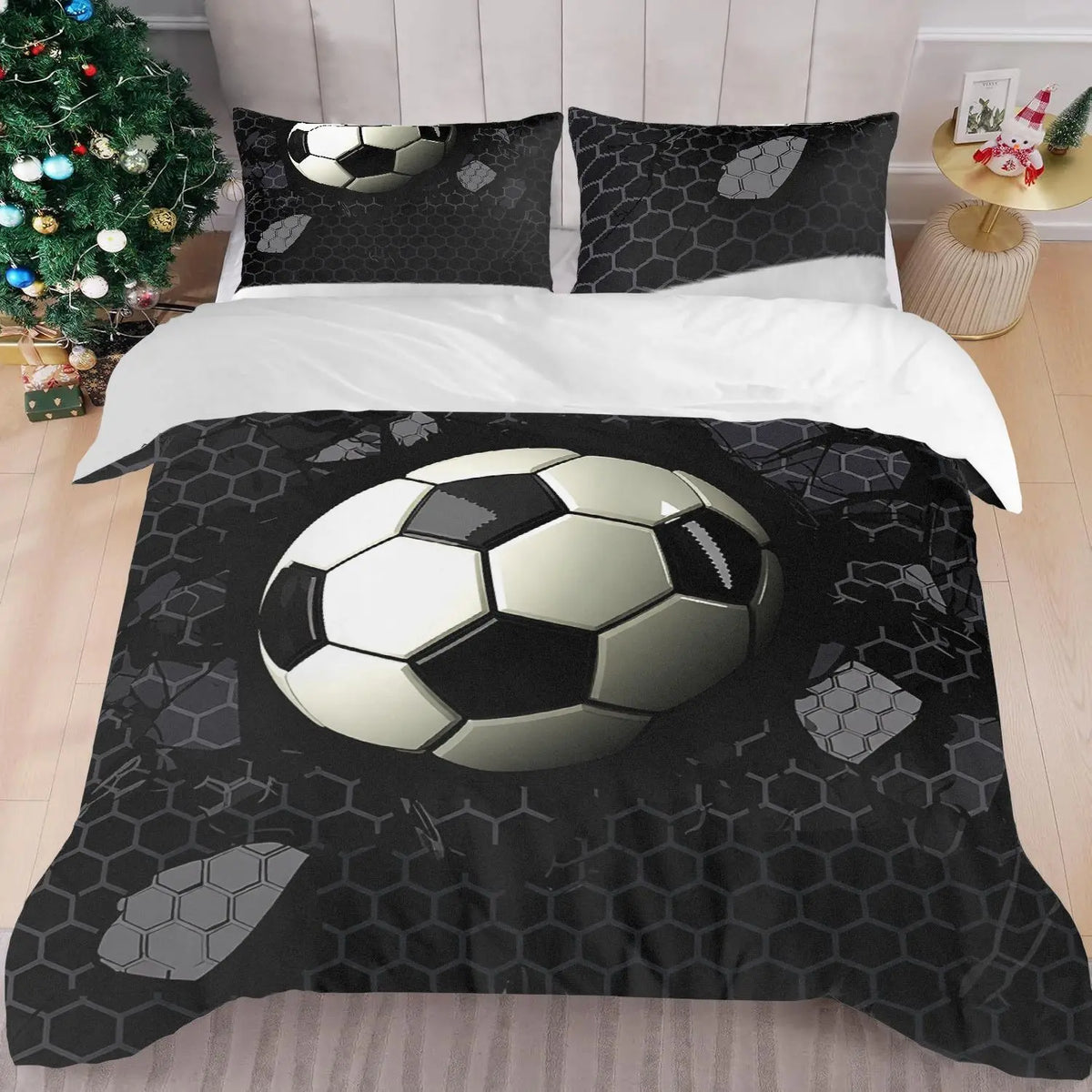 A soccer ball themed bedding set featuring a duvet cover and pillowcases with a black and white honeycomb pattern.