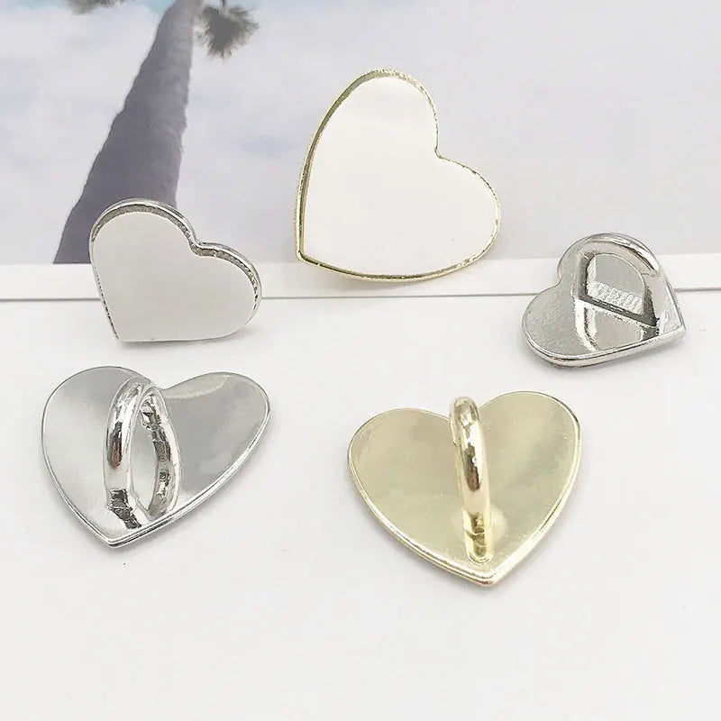 Silver and gold metal heart phone charm connectors displayed on a white background.