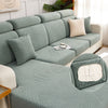 A teal jacquard plush sofa cushion cover featuring a geometric striped pattern on a light-colored sofa.