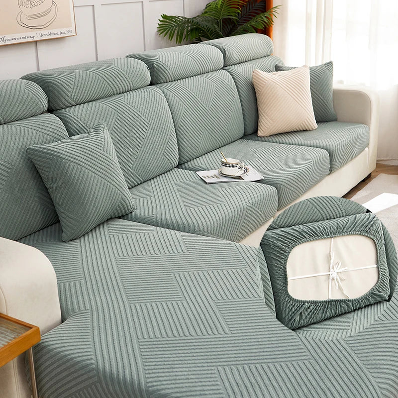 A teal jacquard plush sofa cushion cover featuring a geometric striped pattern on a light-colored sofa.