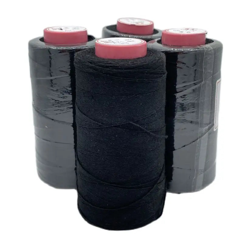 Rolls of black cotton hair weave thread with pink plastic spools for crafting