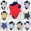 A collection of 12 floral sequins and lace appliqués in various colors including red, purple, black, gold, silver, blue, and 