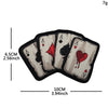A set of five embroidered poker cards featuring aces and a heart, displayed on a black fabric patch.