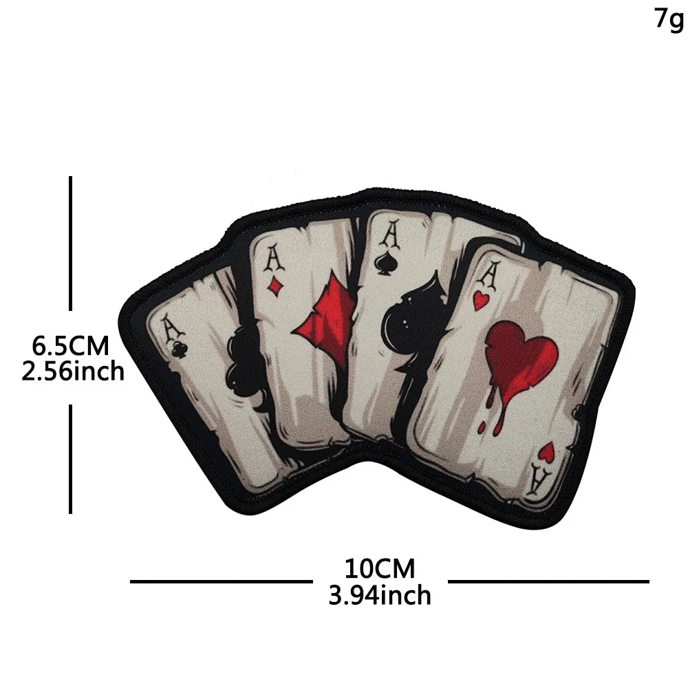 A set of five embroidered poker cards featuring aces and a heart, displayed on a black fabric patch.