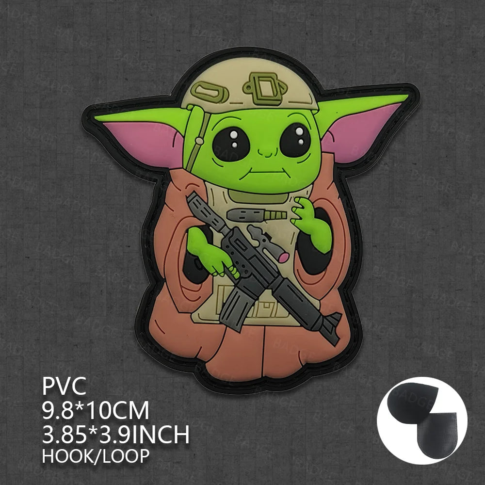 A vinyl sticker of Grogu from Star Wars wearing a brown tunic and holding a blaster.