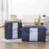 A navy blue portable storage bag with a white quilted insert sits on a wooden floor.