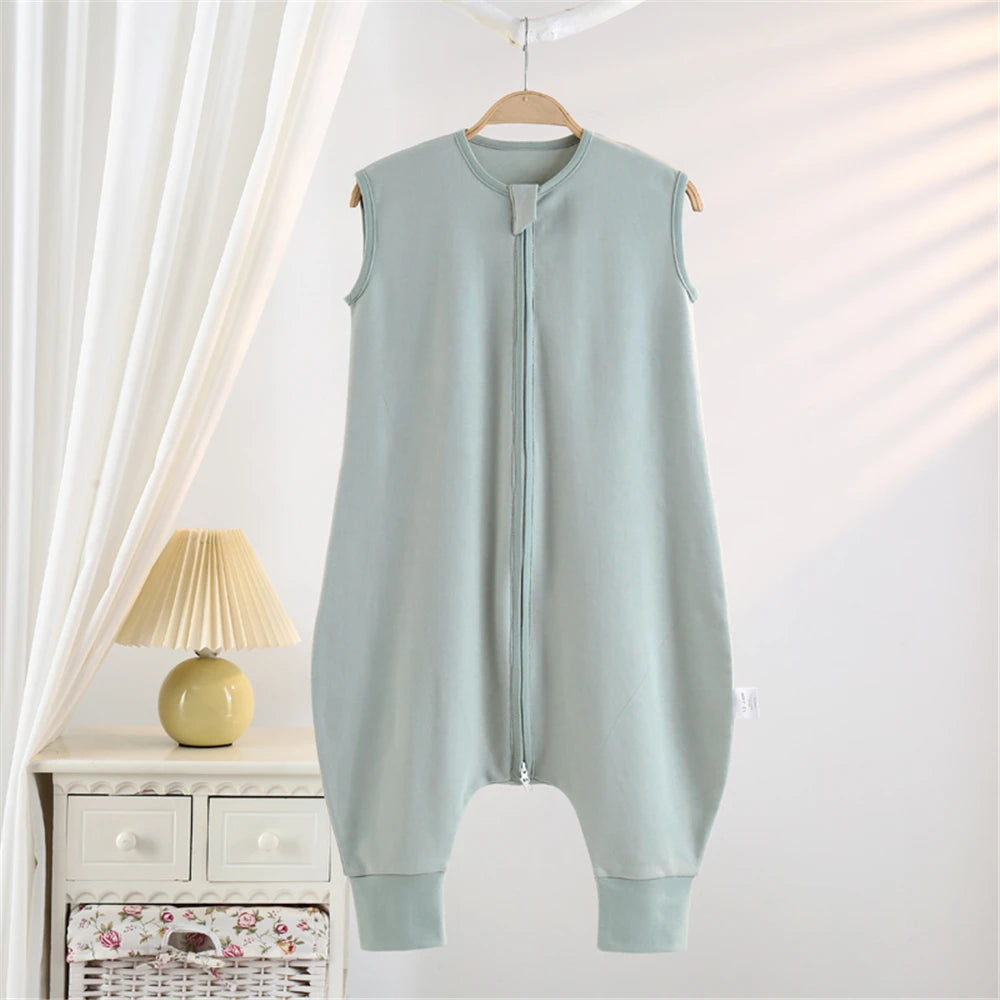 A light blue cotton striped sleeping bag for children hanging on a wooden hanger in a bright room.