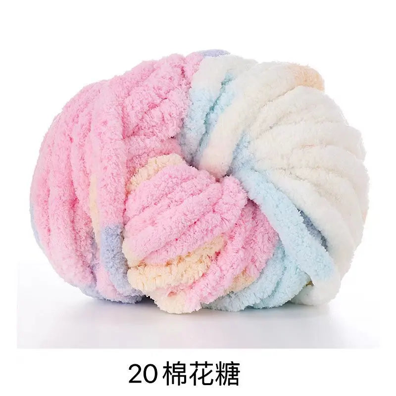 A ball of pink, blue, and white chunky acrylic yarn for knitting and crochet projects.