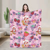 A pink strawberry shortcake plush throw blanket featuring various fruit and floral patterns.