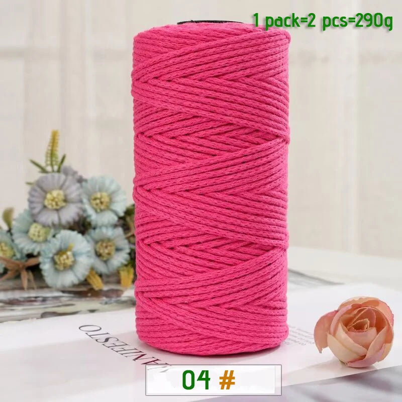 A roll of medium-thick pink yarn used for crafting, with a single ball and two pieces included.