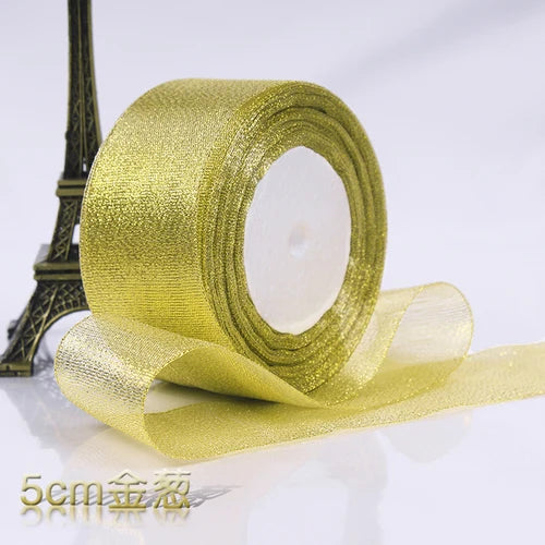 Roll of gold glitter organza ribbon for gift wrapping and DIY crafts