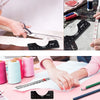 A hand is using a T-Shirt Alignment Ruler set to mark fabric, showing the ruler's markings and alignment tool.