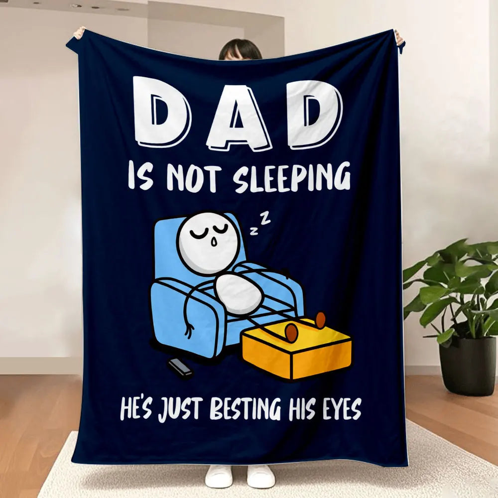 A dark blue blanket with white text that reads Dad is not sleeping and he's just besting his eyes.