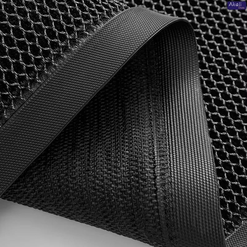 Close-up view of a black half-round non-slip PVC door mat with a textured weave.