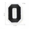 A black felt number patch shaped like the numeral zero with a white center, measuring 3.7 cm by 5.1 cm.