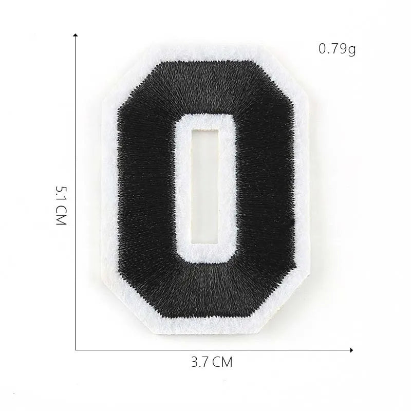A black felt number patch shaped like the numeral zero with a white center, measuring 3.7 cm by 5.1 cm.