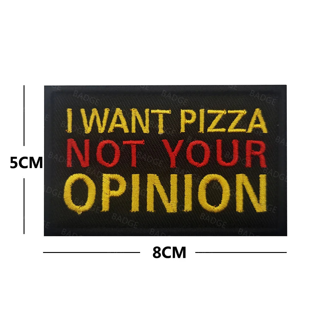 Black embroidered patch with yellow and red text that reads I WANT PIZZA NOT YOUR OPINION