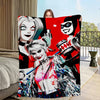 A vibrant red blanket featuring a graphic design of a female character with white hair and dark makeup.