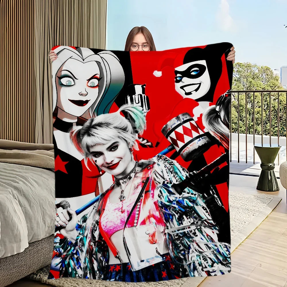 A vibrant red blanket featuring a graphic design of a female character with white hair and dark makeup.