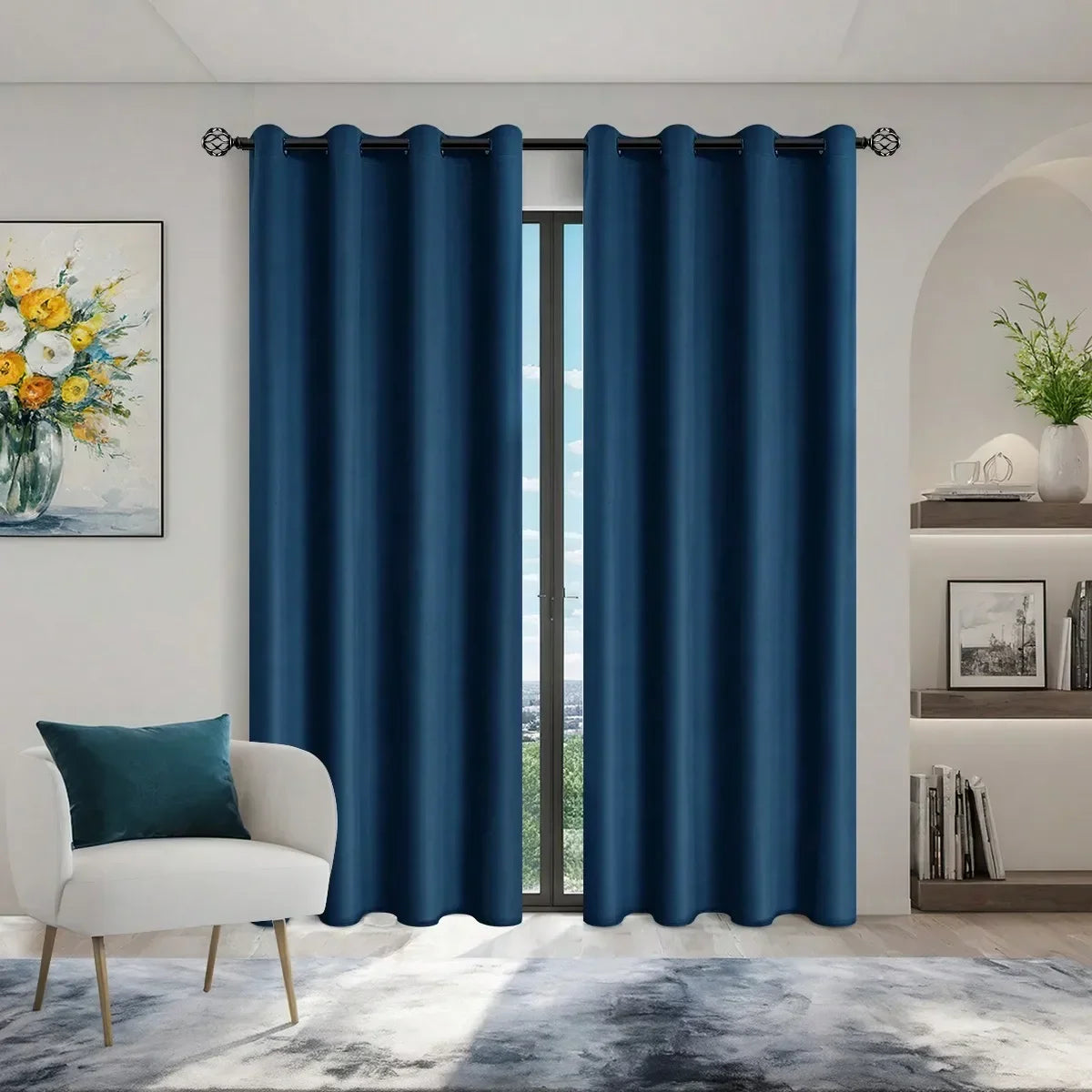 Navy blue blackout window curtains hanging in a doorway with a white chair and artwork.