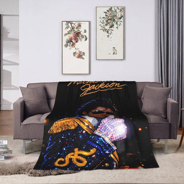 A dark graphic plush throw blanket featuring a person in a blue and gold outfit against a dark background.