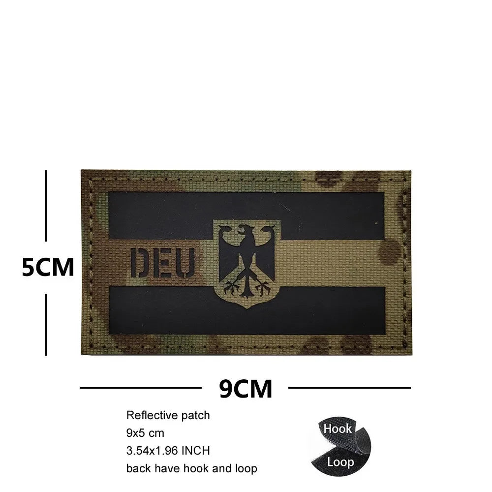 A rectangular dark patch featuring the German eagle emblem and text on a beige background with a woven texture.