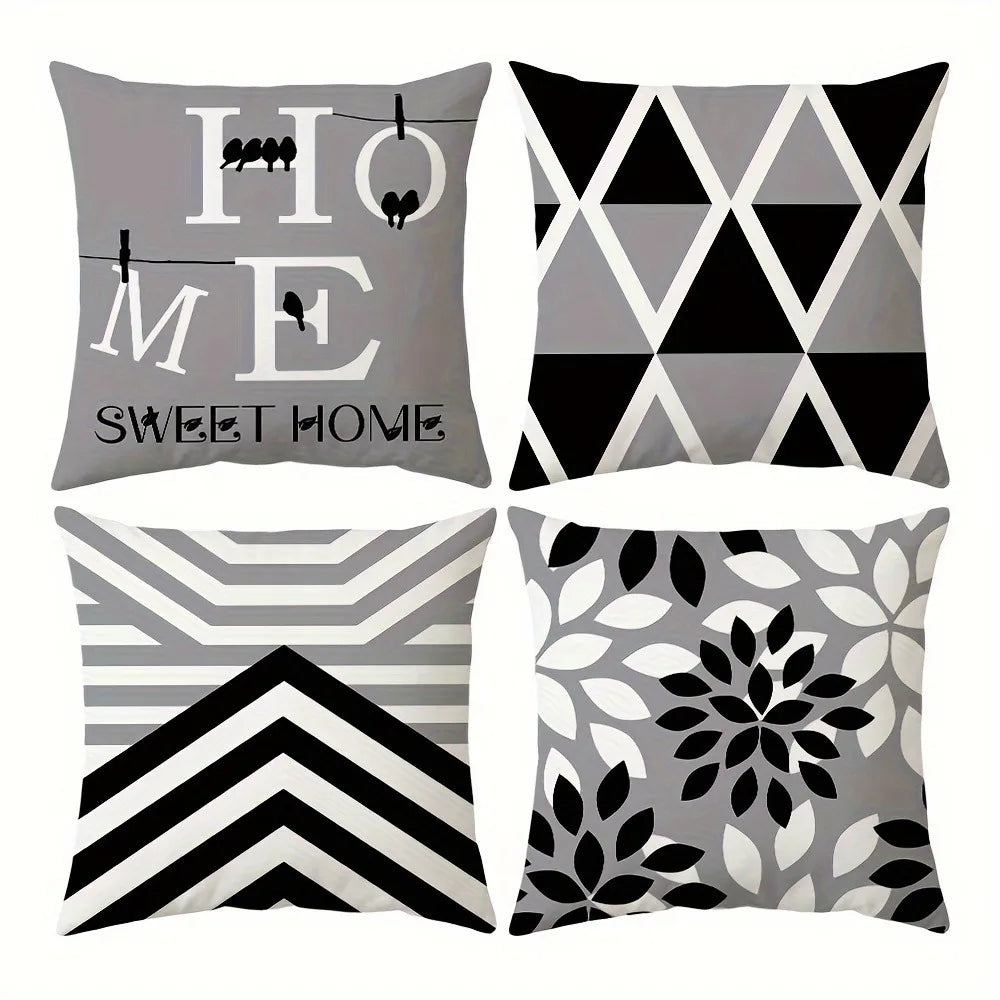 A set of four square pillowcases featuring modern geometric patterns in black, white, and gray.