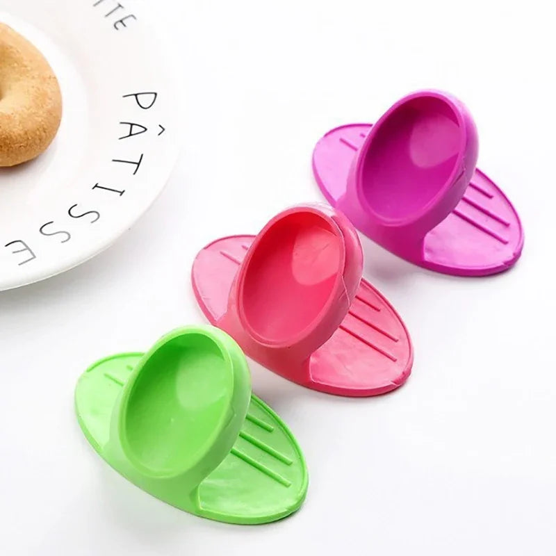 A set of colorful silicone oven mitts and silicone spatulas are displayed on a white background.