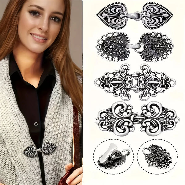 A set of vintage zinc alloy sweater clips in various decorative styles and finishes.