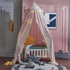 A pink princess hanging bed canopy with gold string lights and a gray stuffed animal in a bedroom setting.