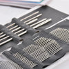 A dark gray pad holds a set of stainless steel hand sewing needles.