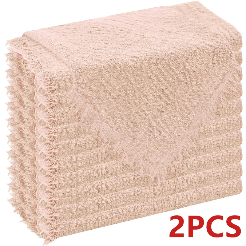 Two beige textured cloth napkins stacked neatly.