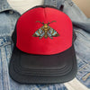 A black baseball cap with a red front featuring an embroidered colorful moth design.