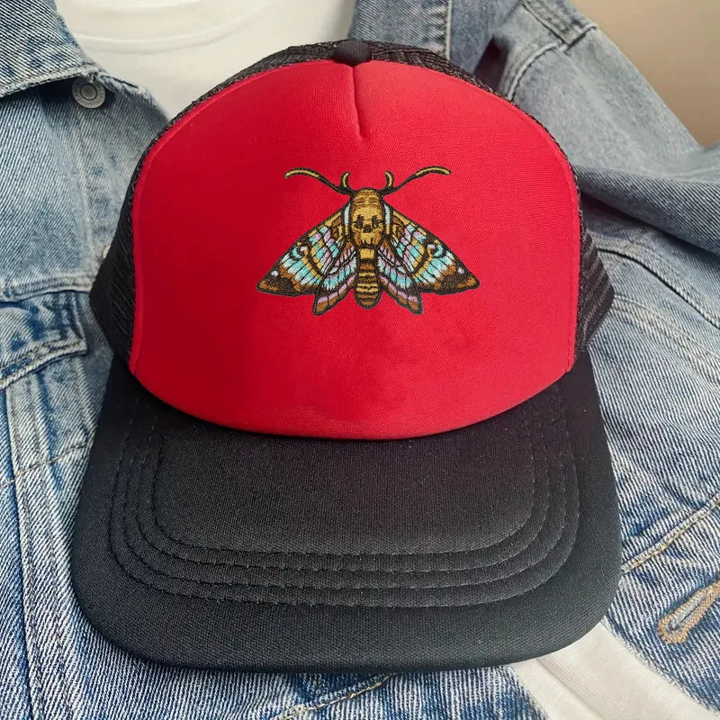 A black baseball cap with a red front featuring an embroidered colorful moth design.