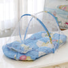 A light blue foldable baby mosquito net sleeping tent with a floral pattern is displayed on a white surface.