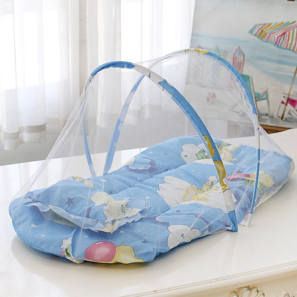 A light blue foldable baby mosquito net sleeping tent with a floral pattern is displayed on a white surface.
