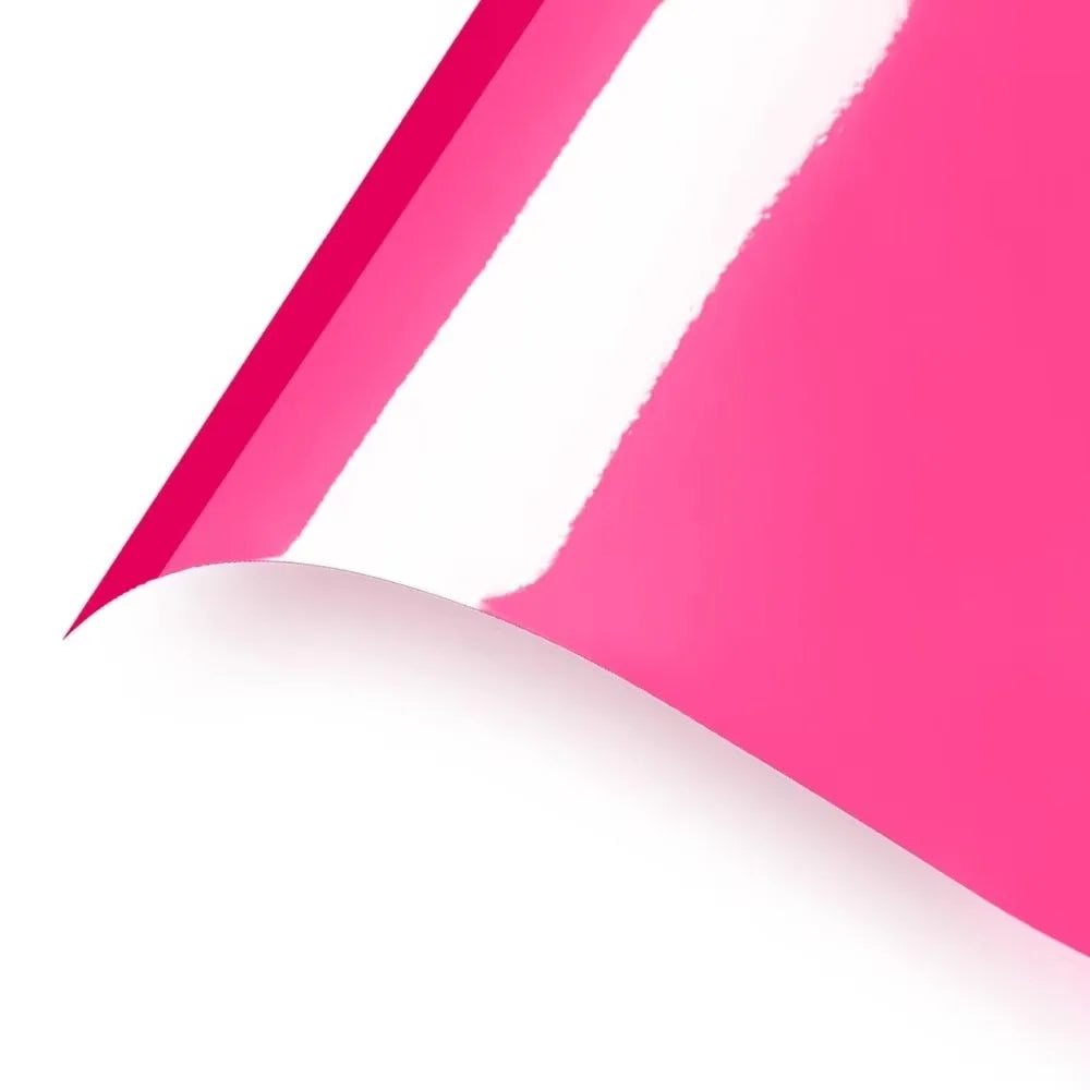 A sheet of pink heat transfer vinyl with a white diagonal stripe, shown in a close-up angle.