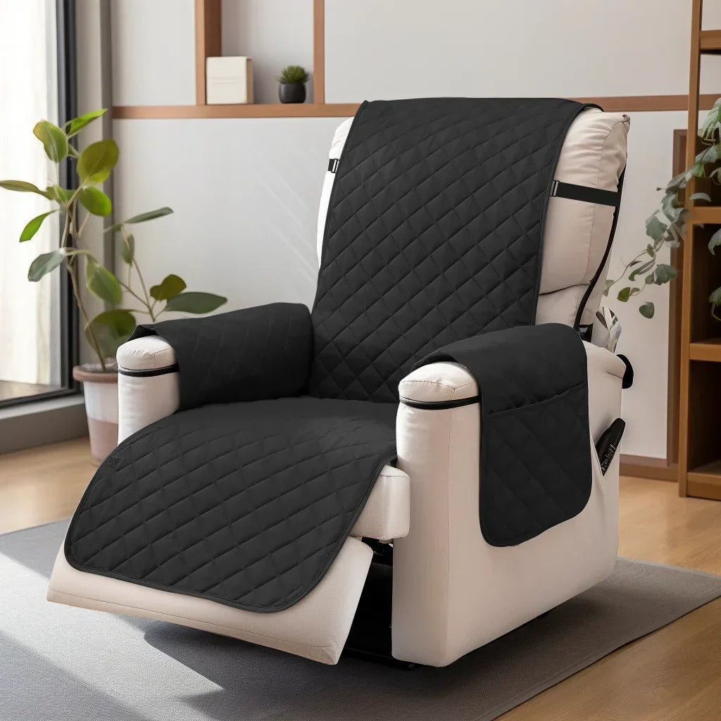 A black washable slipcover with a quilted pattern is shown on a white recliner sofa.