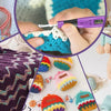 A close-up of hands using an ergonomic crochet hook with an LED and stitch counter to work on colorful yarn projects.