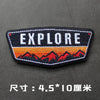 Black embroidered badge with the word EXPLORE in white and orange text on a dark gray background