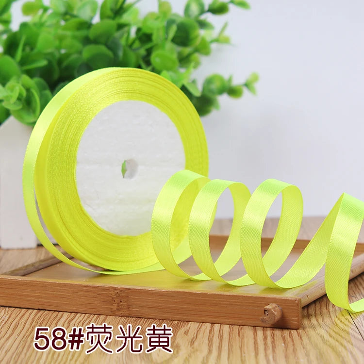 Roll of bright yellow satin ribbon for crafting or gift wrapping