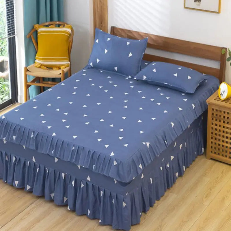 A navy blue fitted bed sheet with a white diamond pattern and lace trim is displayed on a wooden bed.