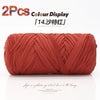 A spool of reddish-orange elastic yarn used for crafting.