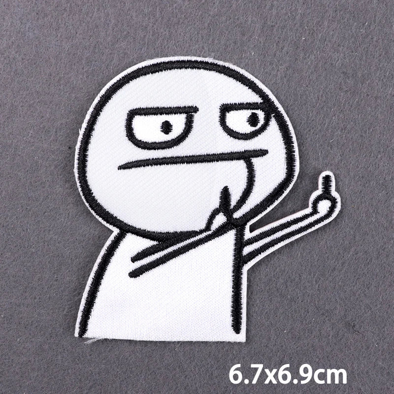 A white embroidered patch depicting a stylized, angry face with raised fingers.
