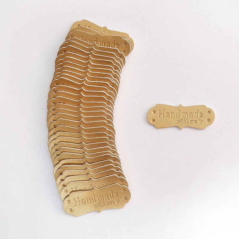 A stack of 50 PU leather embossed tags in a tan color for handmade crafting.