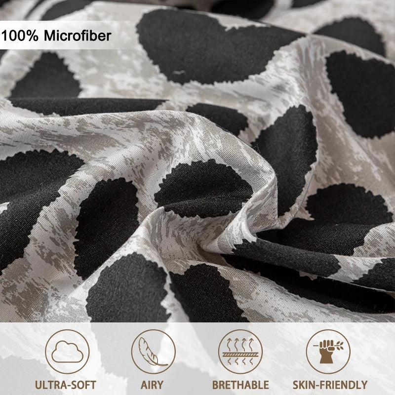 Close-up of a gray and black leopard print microfiber fabric showing its texture and drape.