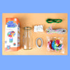 A craft kit box containing felt flowers, a glass bottle, and colored string for making a bouquet.