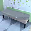 A gray stretch pu leather waterproof bench slipcover placed on a light green wall with small green leaves and black birds.