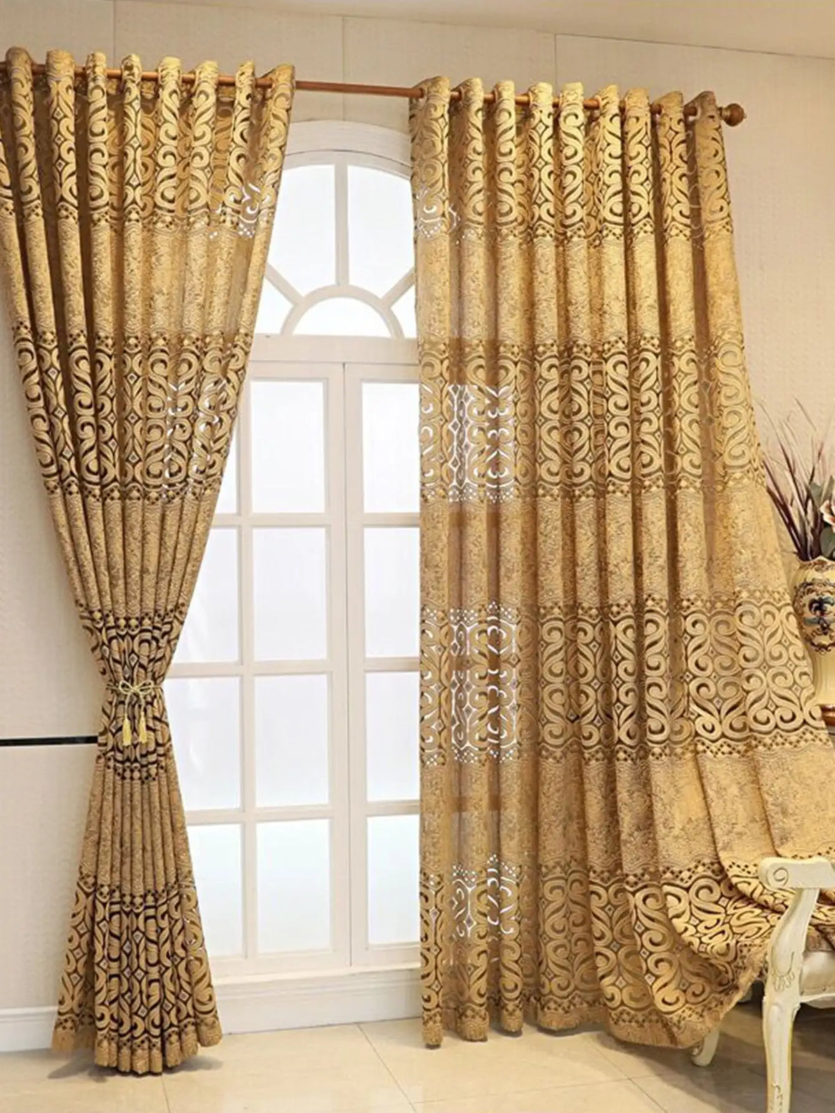 A pair of beige hollow perforated curtains hanging in a white window frame.