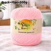 Pink silk bamboo blend yarn skein with a label indicating premium quality